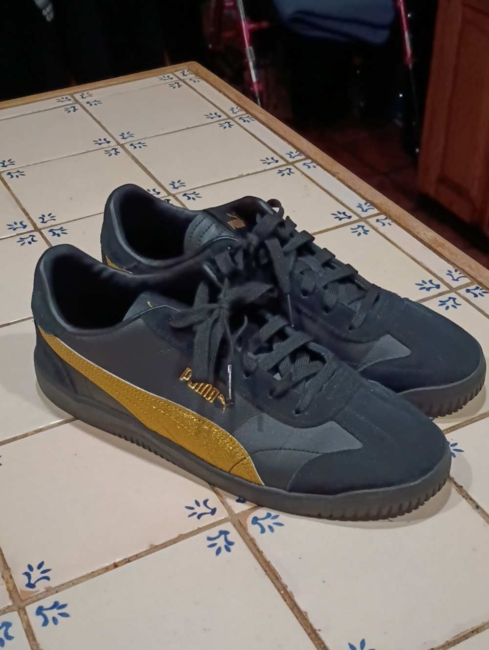 Puma Black and Gold Low-Top Sneakers